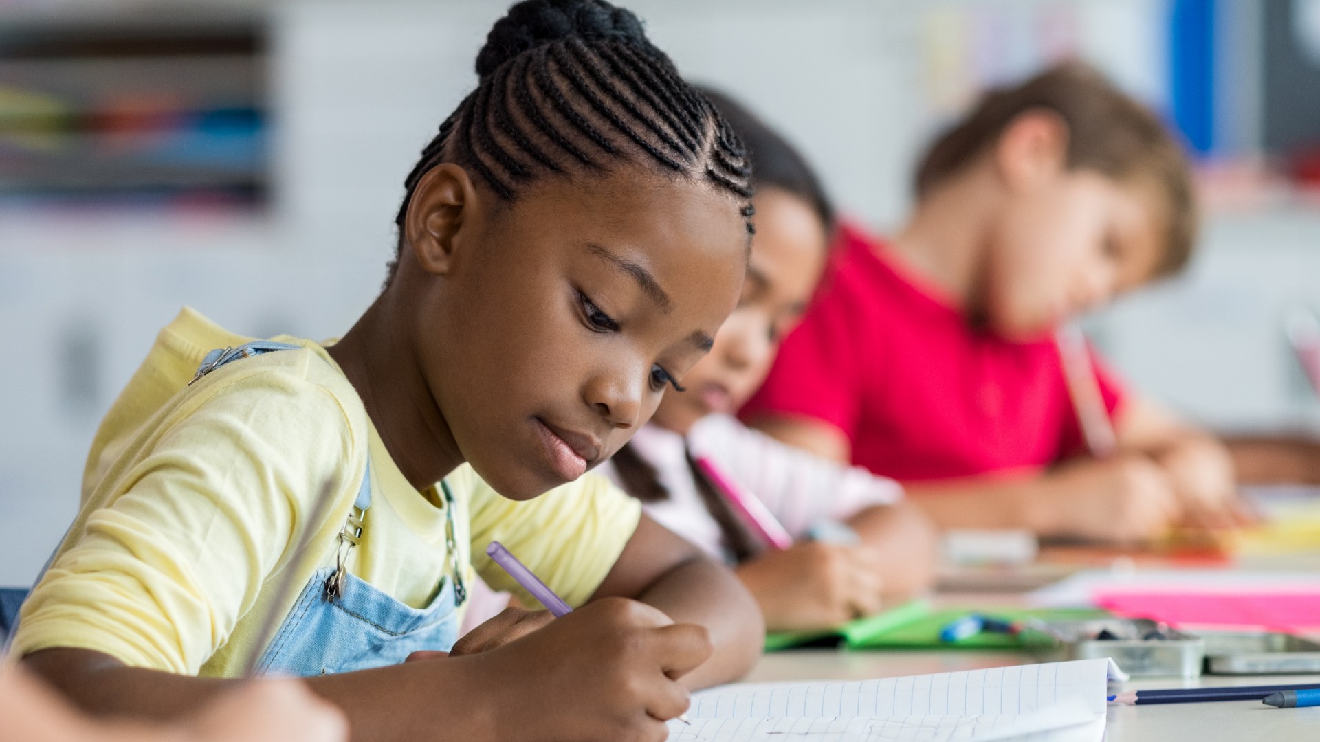 A student concentrating on her work in class